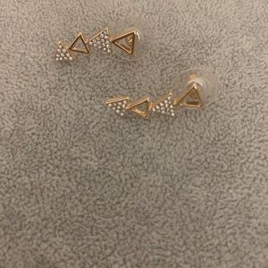Gold triangle earrings goes up the ear